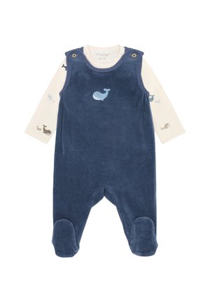 Navy blue baby romper with footies and whale embroidery, layered over cream long-sleeve shirt with small whale prints on sleeves.