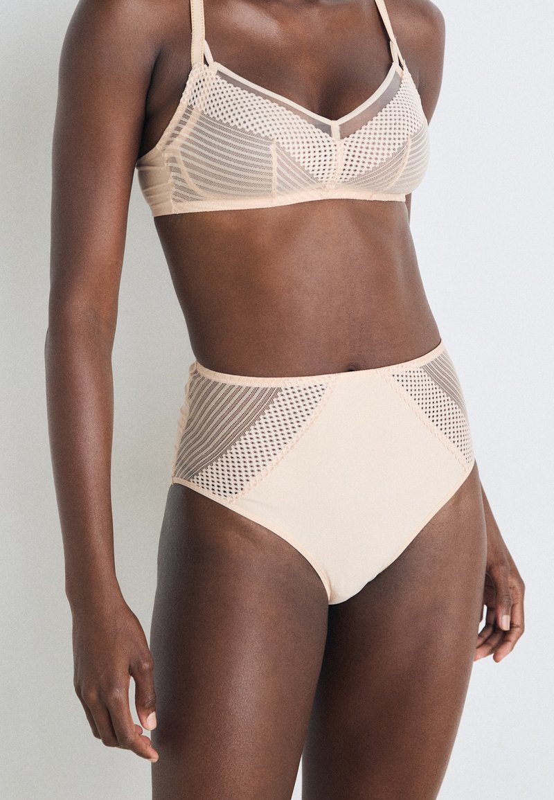 Nude mesh bra and high-waisted brief set featuring geometric patterns, soft texture, and contrasting mesh panels on sides.