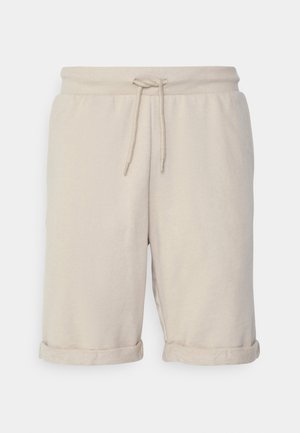 Beige bomullsshorts med strikket midje, rullede ermer og en myk tekstur. Enkel design uten synlige mønstre eller maskinvare.