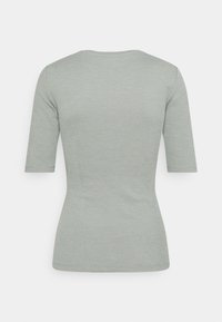 Light green, short-sleeved ribbed top with a round neckline, slim fit, and smooth texture, featuring a simple design without embellishments.