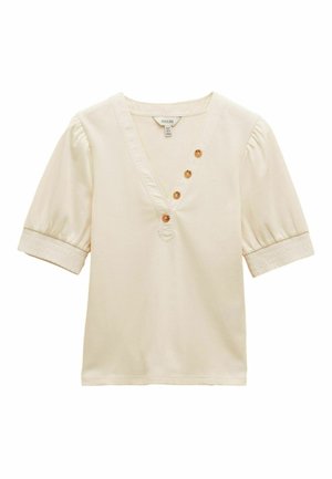 Roomkleurige blouse met korte mouwen en V-hals, vier decoratieve knopen schuin op de borst, en elastische boorden aan de opgeblazen mouwen.