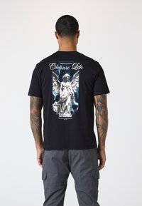Schwarzes Baumwoll-T-Shirt mit einem großen Grafikdruck einer geflügelten Statue auf der Rückseite, darüber steht in weißem Text "Closure Ldn".