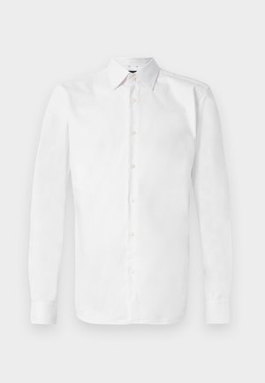 Chemise blanche à manches longues en coton, dotée d'un col classique, d'une fermeture à boutons à l'avant et de détails en boutons aux poignets. Texture lisse.