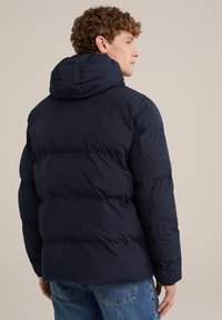 Navy puffer jacket with a hood, featuring a quilted design, shown from the back. The material appears smooth and durable.