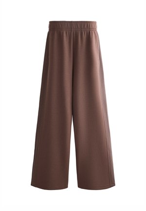 Bruine, wijd uitlopende broek van zachte stof met een elastische tailleband. Heeft een gladde textuur zonder zichtbare patronen of metalen details.