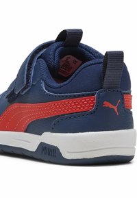 Marineblauwe synthetische sneakers met rode accenten en een witte zool. Voorzien van klittenbandsluiting en een gestructureerde achterlip met logo.