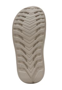 Sole di scarpa in gomma beige con un motivo a zigzag testurizzato, progettata per offrire trazione con scanalature e creste per una maggiore aderenza e flessibilità.