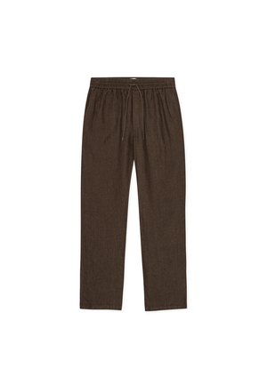 Brune, ledige bukser med elastisk midjebånd og snor. Laget av en teksturert stoff med rette ben og uten synlige beslag.