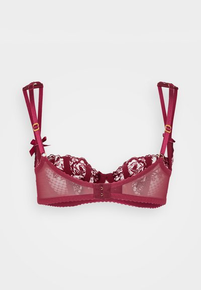 Sutiã de renda cor borgonha com copas de malha transparente, alças ajustáveis, acabamento em tom dourado e detalhes em laço nas alças. Padrão floral texturizado.