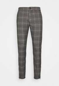 Grå slim-fit-byxor med ett ljust rutmönster, knapstängning, bälteshällor och dragkedjor vid bensluten.