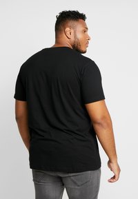 Black short-sleeve t-shirt made of smooth cotton, featuring a round neckline and a relaxed fit; minimalistic design with no patterns.
