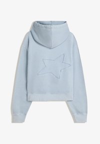 Haut à capuche court bleu clair en tissu doux, arborant un grand design étoile brodé à l'arrière et des poignets côtelés.