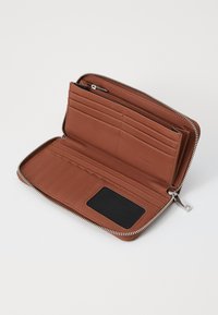 Brown leather wallet with a zip closure, multiple card slots, a transparent ID holder, and a textured interior lining.