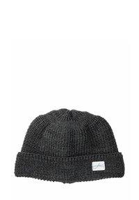 Dark gray knitted beanie with a ribbed cuff, featuring a small white tag with blue text, prominently showcasing its textured material.