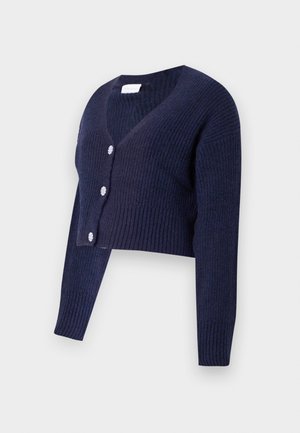Cardigan court bleu marine en maille côtelée. Présente un décollet�é en V profond et quatre boutons ronds décoratifs sur le devant.