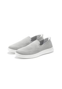 Grüne Slipper aus perforiertem Strickmaterial mit einer weißen Sohle und elastischen Seitenpanelen für einfaches Anziehen.