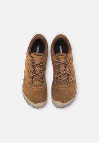 Brown suede outdoor shoes with textured rubber soles, featuring brown and white patterned laces and black inner lining for comfort.