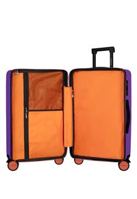 Purple suitcase with orange interior, dual compartments, mesh pocket, and zipper closures. Contains four wheels and a retractable handle.