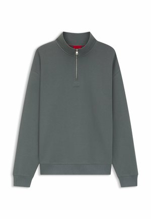 Felpa grigia scuro a maniche lunghe con cerniera a quattro quarti e polsini e orlo a coste, mostrata distesa su uno sfondo bianco.