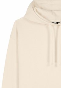 Felpa in cotone color avorio con cappuccio regolabile e testo nero visibile sull'etichetta interna del collo.