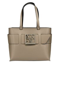 Borsa tote beige con accenti neri, caratterizzata da un logo prominente sulla parte anteriore, due tasche laterali e doppi manici. Texture liscia.