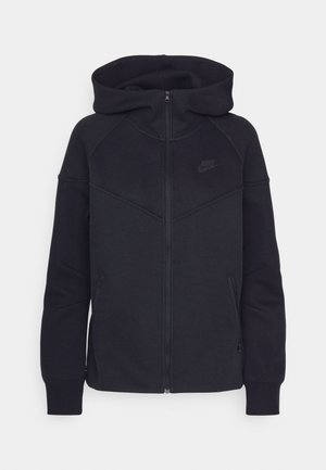 Black zip-up hoodie made of soft fabric, featuring a high collar, hood, and side zip pockets; includes a small black Nike logo on the chest.