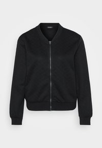 Čierna bomber bunda s textúrovaným prešívaným vzorom, zapínaním na zips, rebrovanými manžetami a lemom, a okrúhlym výstrihom.