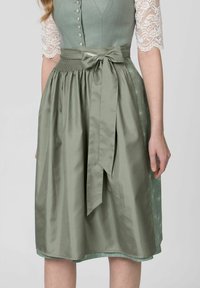 Green dress with a structured bodice and lace sleeves. Featured waistband with a bow, flowing silky skirt, and subtle floral pattern.