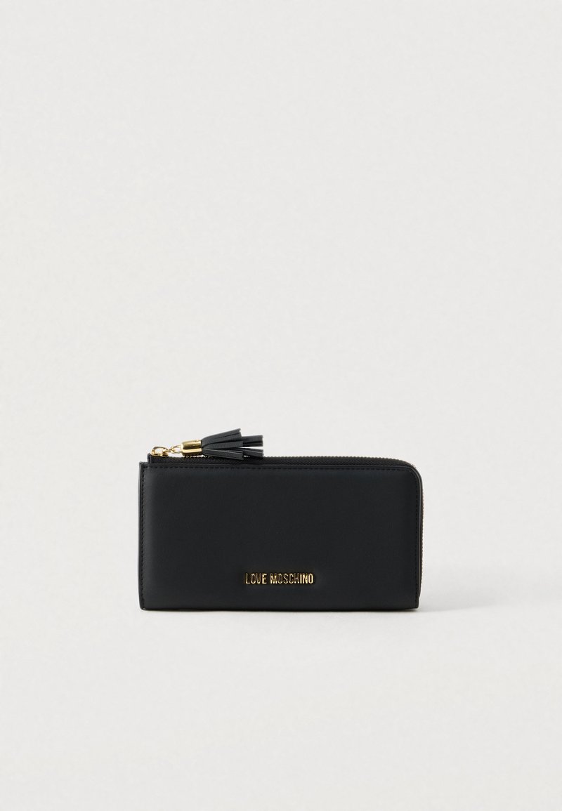Black leather wallet with a zip closure, featuring a gold logo and a black tassel accent. Smooth texture and rectangular shape.