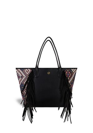 Black tote bag with colorful woven side panel, fringes, and braided accents on handles. Geometric pattern in pink, blue, and cream tones.