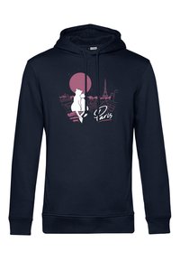 Navyblå hoodie med en framsida grafisk design som visar en silhuett av en katt och Paris skyline, inklusive Eiffeltornet och en rosa sol.