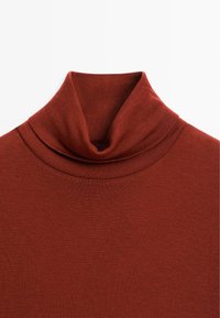 Rust-colored turtleneck sweater made of textured knit fabric, featuring a folded neckline and fitted design, with no visible fastenings.