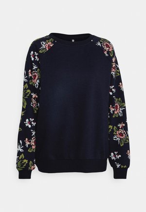 Navy sweatshirt with floral-patterned sleeves in pink, green, and white. Crew neckline, ribbed cuffs, and soft fabric.