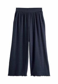 Tumes sinised culotte püksid pehmest kangast, millel on elastne vöökoht, küljetaskud ja laineline alläär lisadetailideks.