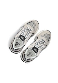 Grey and white sports shoes with mesh upper, black accents, and logo. Features round laces and a thick, textured sole.
