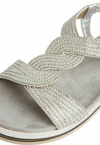 Silver sandals with multi-strand beaded accents, suede footbed, flat sole, and a padded toe strap for comfort.