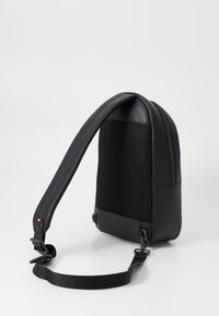 Tommy Hilfiger MONOGRAM SLING BAG - Bum bag - black