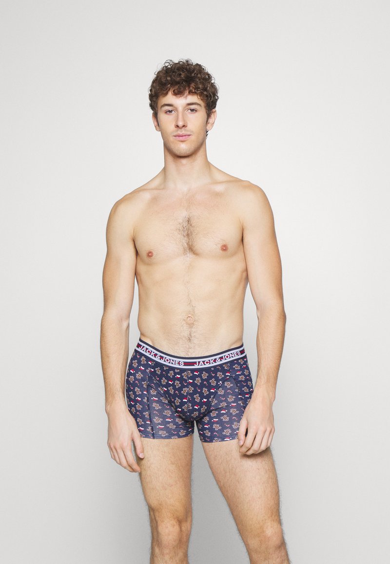 Navyfarbene Boxerbriefs mit einem floralen Muster, ausgestattet mit einem weißen Bündchen, das "JACK & JONES" beschriftet ist. Hergestellt aus dehnbarem Stoff für zusätzlichen Komfort.