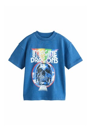 Blue short-sleeve t-shirt with "Imagine Dragons" text in rainbow colors above a large skull graphic inside a circular frame.