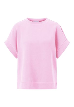 Ružičasta pamučna oversized majica kratkih rukava s preklopom, okruglim izrezom i ravnim rubom. Glatka tekstura bez vidljivih uzoraka ili detalja.