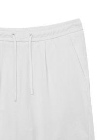 Pantaloni della tuta bianchi realizzati in materiale testurizzato, con vita elastica, chiusura con cordino e tasche laterali.