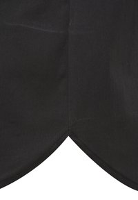 Black fabric with a smooth texture, featuring a pointed, scalloped edge seam at the bottom corner. No visible patterns or hardware.
