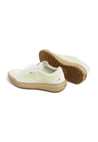 White canvas sneakers with a mint green accent and patterned gum sole. Features textured mesh and lace-up closure.