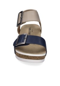 Sandale marine et beige avec deux boucles réglables, semelle en liège, base texturée et semelle extérieure blanche. Conçue pour le confort et la stabilité.
