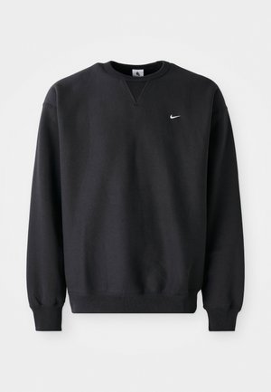 Black Nike sweatshirt featuring a round neckline and long sleeves, with the iconic swoosh logo in white on the chest.