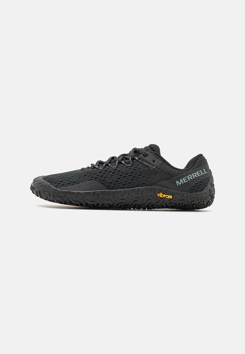 Black lightweight shoe with a textured mesh upper, low-profile design, and rugged rubber sole featuring a prominent Vibram logo.