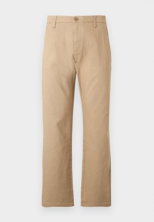 Beige rette benbukser laget av en blanding av bomull. Har en frontknapp og to sidelommer med en jevn tekstur.