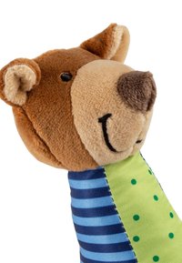 Stuffed bear toy with a brown plush head, smiling face, and brown nose; blue striped fabric body with a green polka-dotted accent.