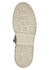 Zapato marrón con suela de goma beige que presenta un patrón texturizado de formas en X y una marca, diseñado para ofrecer tracción y durabilidad.