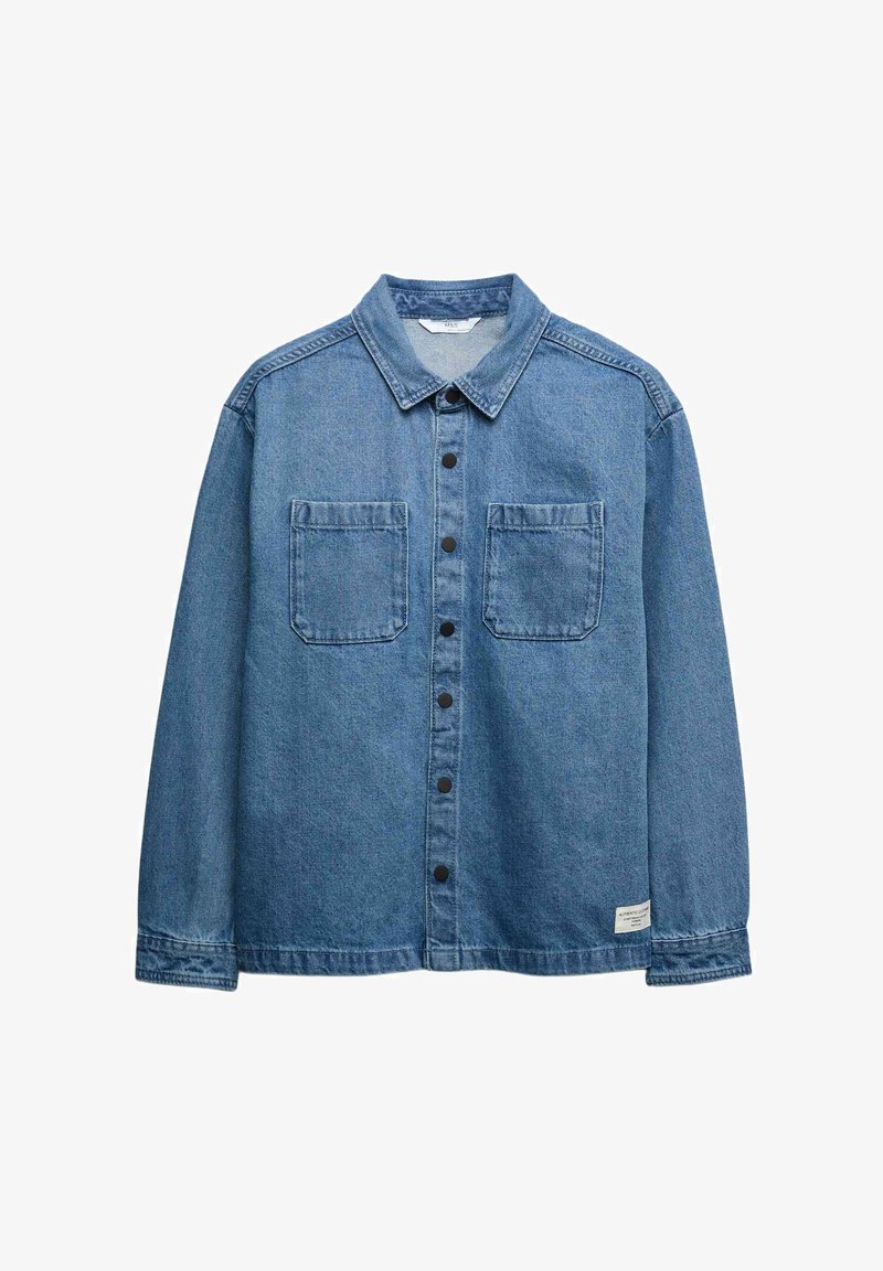Blue denim long-sleeve shirt with collar, black snap buttons down front, two chest pockets, and a small label near the hem on the left side.